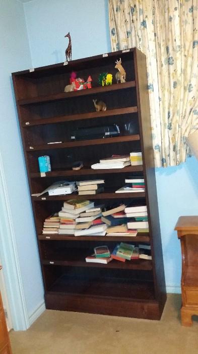 Tall wood bookcase, tagged Texas A&M