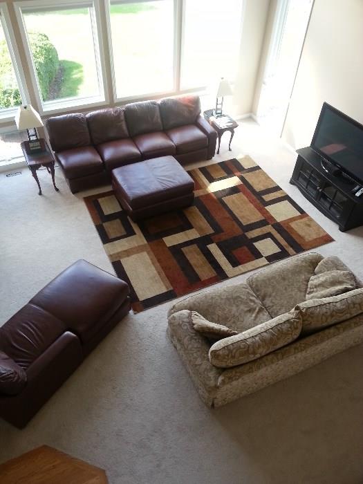 TV is not for sale. Rug, leather L shape sofa, Tan sofa, end tables, lamps..all go. 