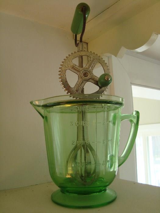 green measuring cup with hand mixer