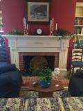 Two blue recliners; two ladder back chairs; small coffee table; large brass tray (in fireplace)