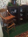       Antique high chair; antique display cabinet