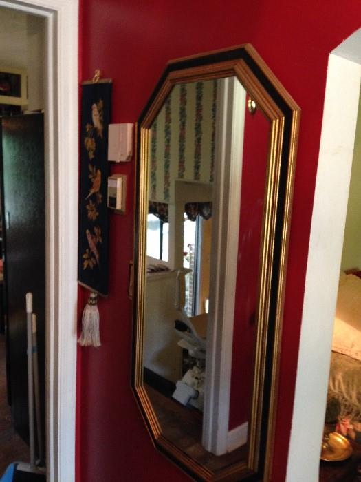 Octagonal shaped Black and gold mirror good anywhere vertically or horizontally placed.