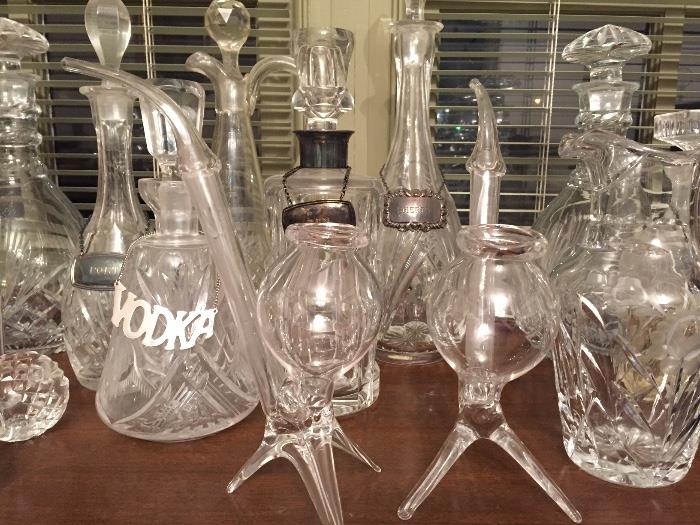 Glass pipes and crystal decanters with sterling and pewter liqueur collars.