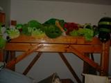 Many overstuffed frogs, and animals on the bunk bed