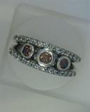 three cognac diamonds  weighing .54 ct with .38ct white diamonds in a 14k white gold band style ring