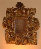 18th Century Hand Carved Wood Frame with traces of paint and gilt, having a small looking glass.