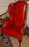 Large Wing Chair covered in a warm red Leather, 20th Century.