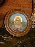 Small oil on board of a Saint with a brass cross and a terracotta cherub.