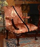 Late 19th Century English open arm chair with ball and claw feet.
