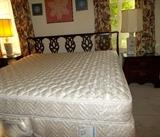 King-size bed with mahogany, chair-back headboard . 