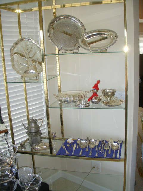 Silverplate pieces displayed on brass & glass etagere