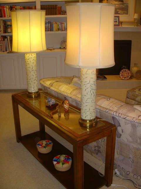 Pair of lamps made from wallpaper printing rollers on a nice sofa table with glass inset top
