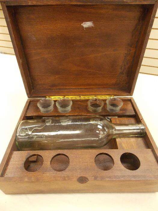 A music box!  This vintage bottle and shot glass box is also a music box!  Great collector's item!