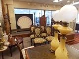 Front view of gallery with a Shell Sign in the window. Balloon backed chairs with embroidery, oil lamps...and so much more!