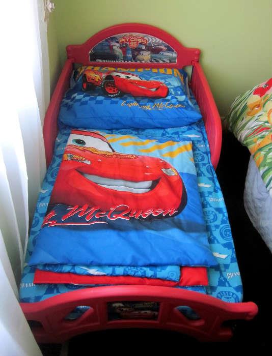 Toddler bed, Lightening McQueen Pit Crew 95.  Matching bedding sold seperately.