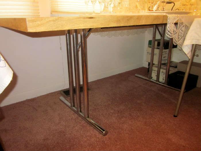 Nice modern style table with tubular stainless steel legs, comes with one leaf.
