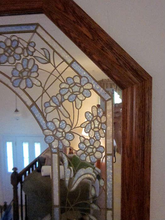 Large octogonal wall mirror with wood frame and applied blue/pearl decoration.