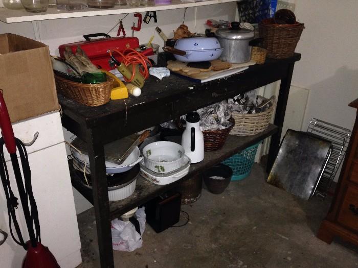 Lots of kitchen gadgets but notice this great antique wooden workbench, saw another white painted bench seat in garage, dozens of baskets
