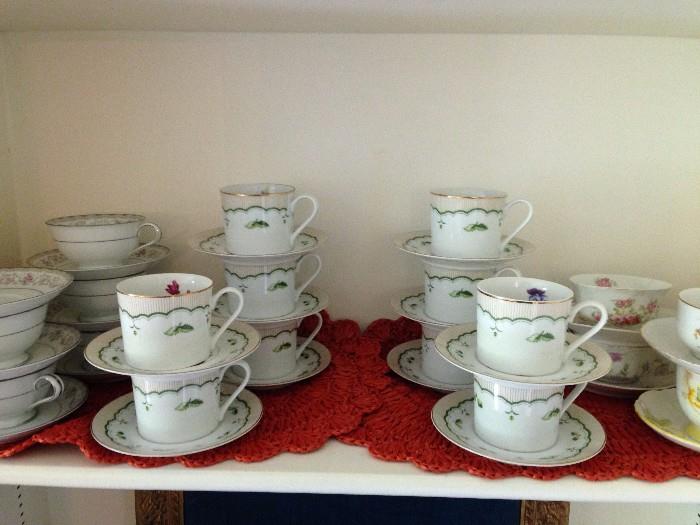 About 20 sets of cups and saucers