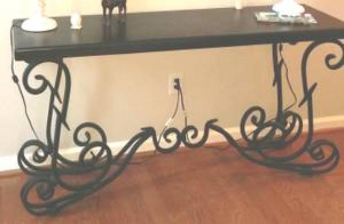 Gorgeous and well crafted solid sofa table with thick wrought iron and a solid piece of wood in a mahogany finish. This piece is made to stand the test of time!