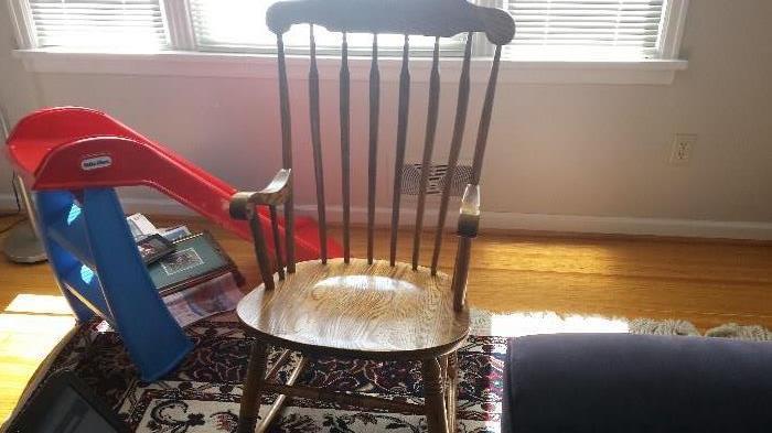 Oak, medium brown rocker.  35 years old and in very good condition. Original finish.