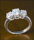 DIAMOND AND PLATINUM RING, FEATURING THREE ROUND, BRILLIANT-CUT DIAMONDS (lot 663)