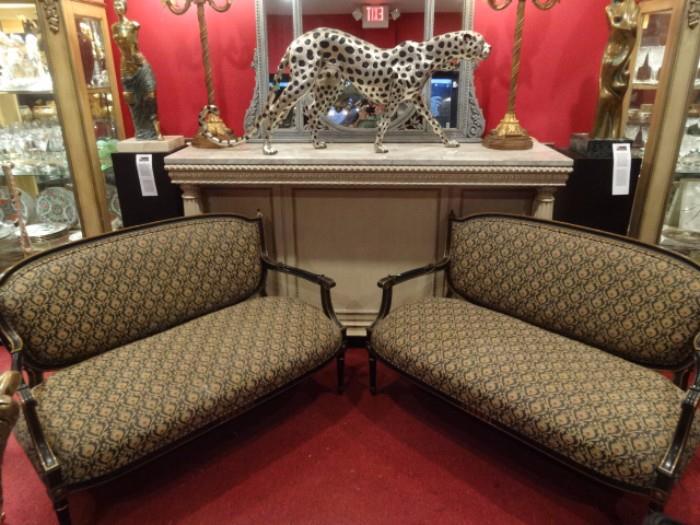 TWO VINTAGE LOUIS XVI STYLE LOVESEATS IN BLACK AND GOLD GILT