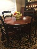 Brown/black table with 6 chairs (has matching hutch); India Sultan 8 foot round 100% wool rug