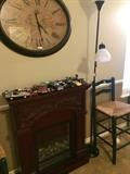 Faux fire place; model cars; large wall clock; 1 of 2 black bar stools