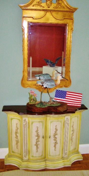 Gold gilded wall mirror; blue heron; two-door cabinet