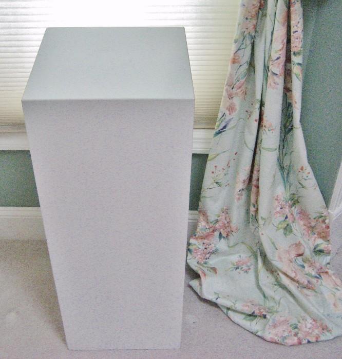One of six white display pedestals