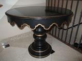 CUSTOM ROUND BLACK SCALLOPED TABLE WITH GOLD ACCENTS  TURNED PEDESTAL ON ROUND BASE.
