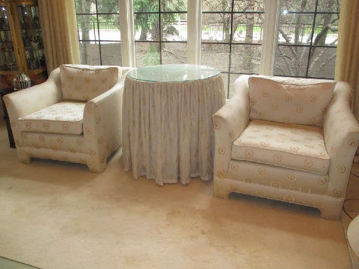 UPHOLSTERED ARM CHAIRS IN CUSTOM FABRIC ROUND TABLE WITH CUSTOM TABLESKIRT AND GLASS TOP