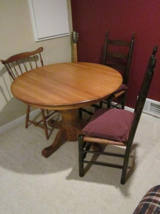 Vintage round oak table and odd chairs.