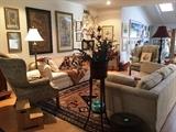 Pair of white sofas, wing back chairs, floor and table lamps, artwork