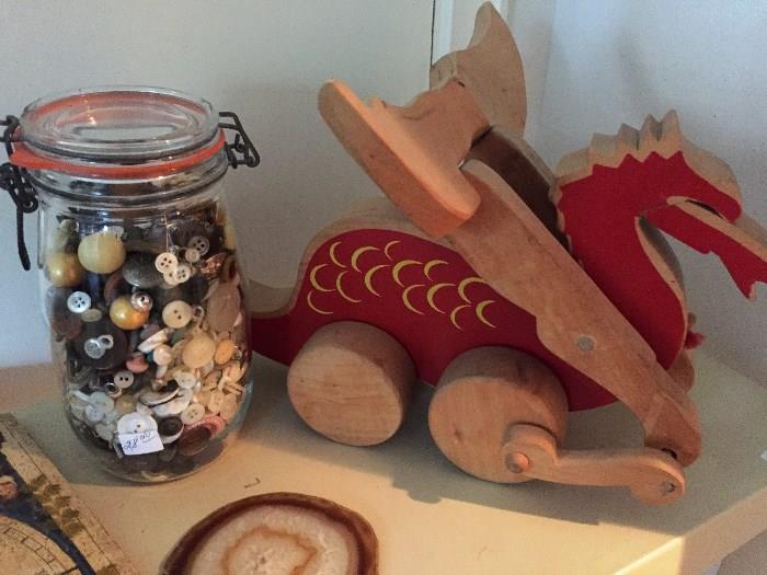 Jar of buttons, agate slice, wooden dragon toy
