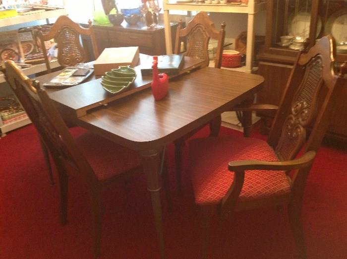 dinette table, 2 leaves, 4 chairs (2 with arms) with funky carving look backs