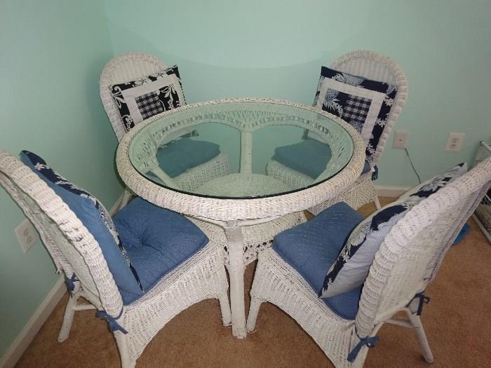 Wicker table with Glass Top and four chairs with pillows