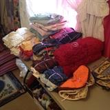 Bundled blankets, sheets, linen, lace tablecloth