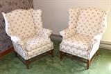 Upholstered wing back chairs.