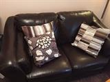 LEATHER LOVESEAT AND DECORATIVE PILLOWS