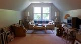 Upstairs bonus room with assortment of furniture, prints, pictures, sewing machine, treadmill, lamps, etc