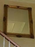 Large beveled-edge mirror in gold-tone frame.