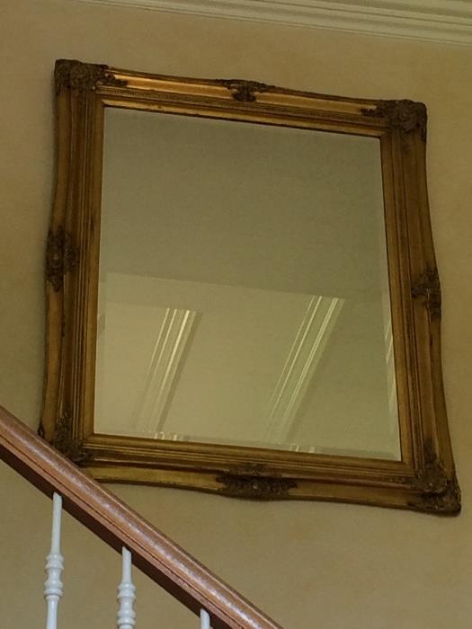 Large beveled-edge mirror in gold-tone frame.