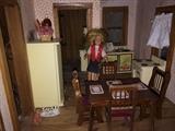 Large wooden dollhouse full of furniture and accessories.
