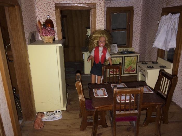 Large wooden dollhouse full of furniture and accessories.