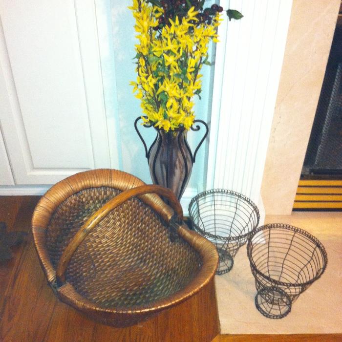 Contemporary décor--basket, wire planters, tall vase with faux flowers.