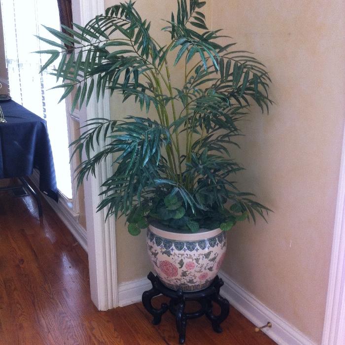 Decorative pot with stand with faux plant.