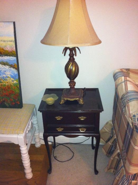 Small two-drawer table and lamp.