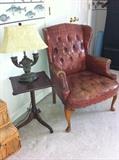 Vintage wingback chair, small table and lamp.